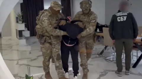 Ukraine said a Hungarian spy was detained in the eastern Ukrainian region of Transcarpathia. A man dressed in black can be seen in between two men dressed in army camouflage outfits as he is lead out of an apartment