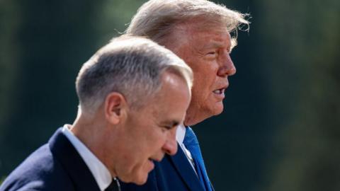 Mark Carney and Donald Trump, shown from the shoulders up, walk side by side. Both are in dark blue suits and stand against an out of focus background. 