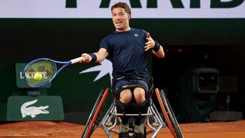 Alfie Hewett is in a wheelchair and swinging a tennis racquet