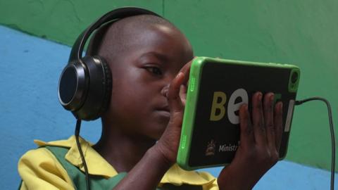 child in Malawi school with tablet