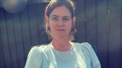 Samantha Lee smiling and looking at camera.
