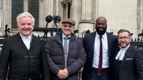 An image showing Mr Afriyie and his legal team standing outside the Royal Courts of Justice. Left to right: Richard Clayton KC, barrister David Hughes, Edwin Afriyie, and solicitor advocate Kevin Donoghue