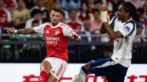 Ben White puts in a cross against Tottenham