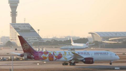 A Juneyao Airlines Boeing 787 Dreamliner plane lands at Shanghai Pudong International Airport