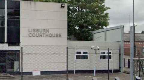 The exterior of a grey building with a sign reading Lisburn Courthouse. 