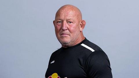 Newcastle director of rugby Steve Diamond looks stern wearing the club's new Red Bulls colours.