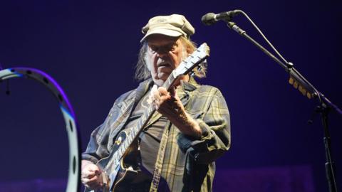 Neil Young performing on the Pyramid Stage during the Glastonbury Festival at Worthy Farm in Somerset.