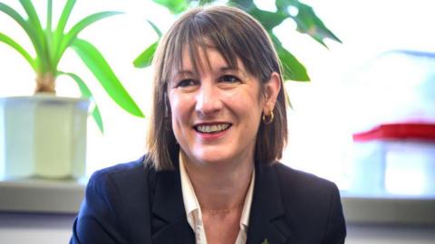 Chancellor Rachel Reeves sitting in front of a window