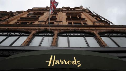 Harrods storefront is seen with a union flag flying, taken from the street looking up, in London in 2010