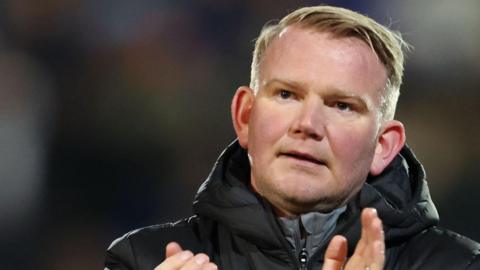 Pete Wild applauds during Tranmere Rovers' fixture against Fleetwood Town earlier this season