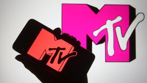 The MTV logo is shown on a telephone, as well as being projected on a TV screen