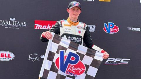 British motorsport driver Liam McNeilly celebrates winning a race in the USF Juniors championship