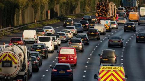 A traffic jam of cars, vans and lorries on the M25. 