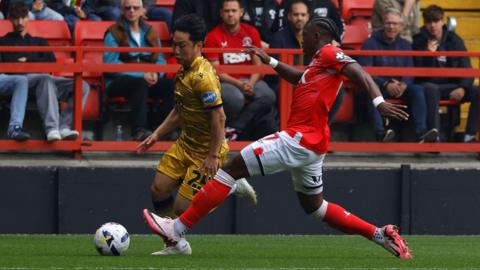 Blackburn Rovers player Ryoya Morishita tries to evade the tackle of Charlton Athletic's Amari'i Bell.