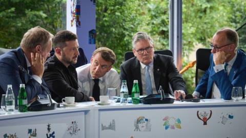 Starmer at a table with Merz, Macron, Zelensky, and Donald Tusk