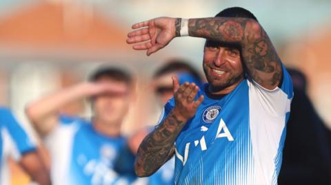 Jack Hunt partially shielding his face from the sun during a game