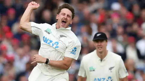 New Zealand bowler Nathan Smith jumps in celebration after taking a wicket