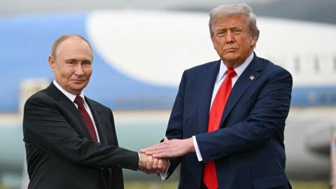 Russian President Vladimir Putin and US president Donald Trump shaking hands