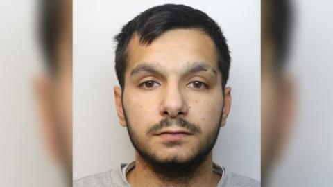 Ivan Godla mugshot against a grey background