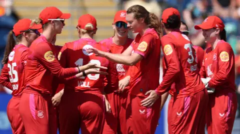 Grace Potts and Welsh Fire fielders celebrate