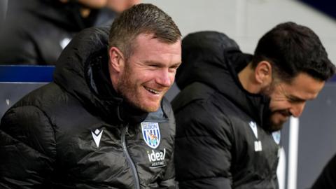 Chris Brunt smiles in the dugout during West Brom's win over Preston North End