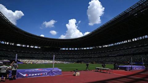 The sun shining above the Japan National Stadium in Tokyo