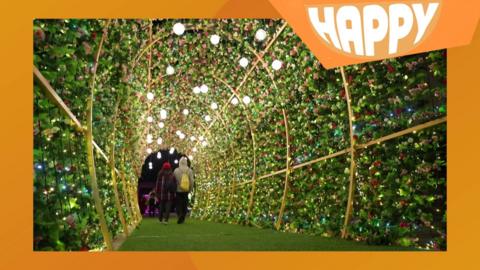 A garden tunnel and the happy logo