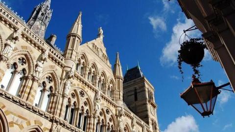 A view of the exterior of the upper floors of Northampton Guildhall on a sunny day.