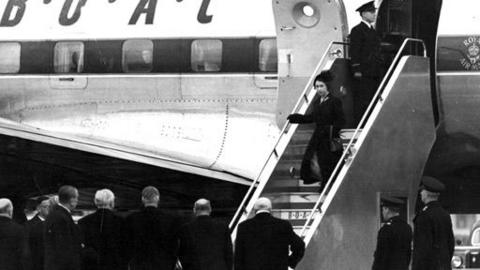 Queen Elizabeth disembarking a plane on her return to the UK.