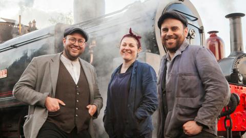 Volunteers at the World's Oldest Railway standing in front of a steam train