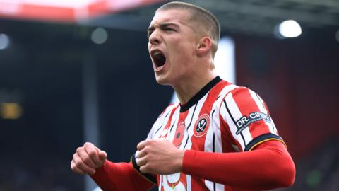 Alfie Gilchrist pumps his fists and shouts at the crowd trying to whip them up during a match for Sheffield United