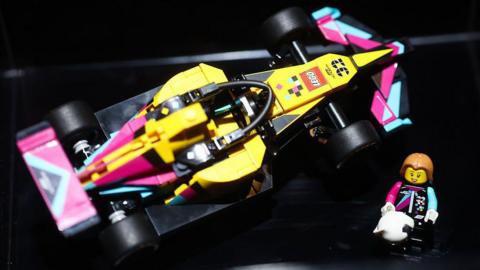 A Lego creation of a Formula 1 car and driver taken from above.