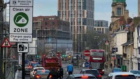 Rush hour traffic with buses, cars and bikes travelling through Old Market.