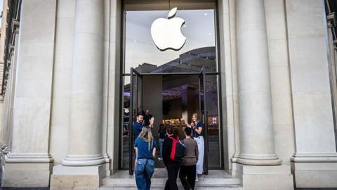 Customers standing in front of an Apple Store in Barcelona, Spain.