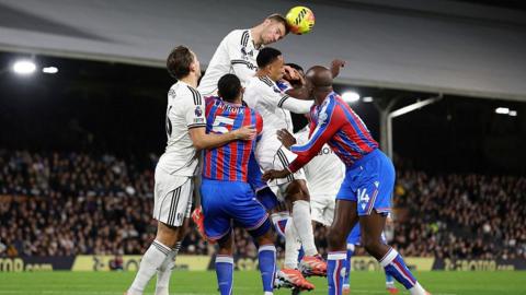 Joachim Andersen heads a ball clear for Fulham