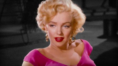 Marilyn Munroe, wearing a pink dress