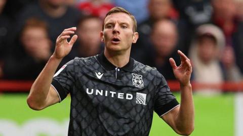 Paul Mullin reacts to a close shot