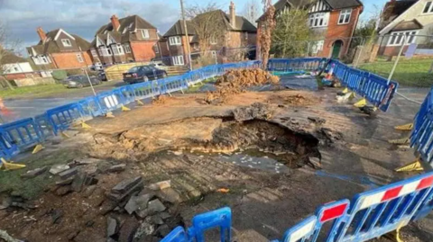 Burst water pipe on Kidmore Road, Caversham Heights, Berkshire