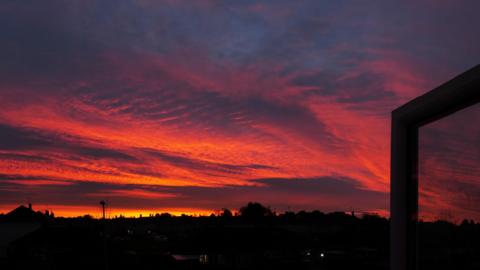 Sunrise in Exhall, Warwickshire, where the sky turned vivid red and orange colours with the town in the background 