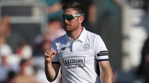 Hampshire bowler Liam Dawson pumps his fist after taking a wicket 