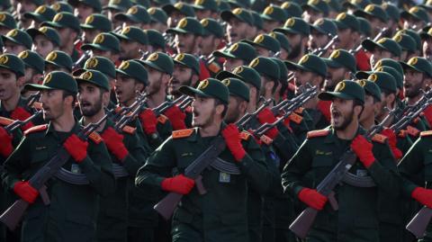 Iranian Revolutionary Guard Corps (IRGC) soldiers march in formation during the annual military parade marking the Iraqi invasion in 1980