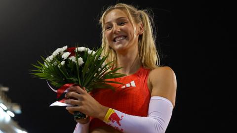 Molly Caudary celebrates winning the pole vault at the Diamond League meeting in Doha