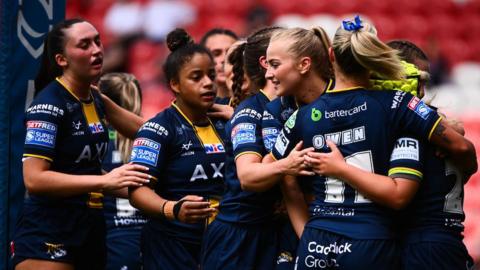 Leeds Rhinos celebrating after scoring a try against St Helens.