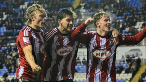 Exeter City players celebrate Luca Woodhouse's goal at Reading
