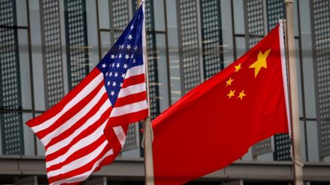 Flags of the US (left) and China. File photo