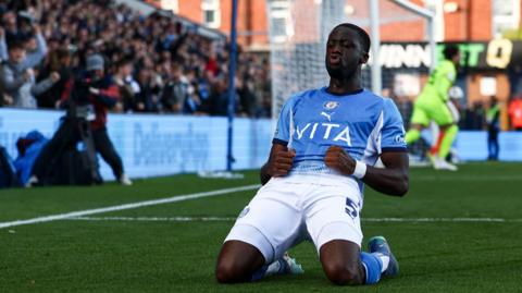 Joseph Olowu celebrates scoring for Stockport against Blackpool