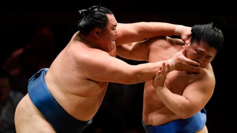 Wakatakakage (right) and Tamawashi in the Makuuchi Division bout on day one of the Grand Sumo Tournament at the Royal Albert Hall