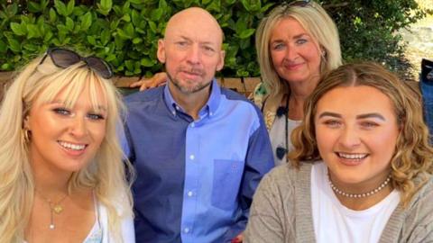 Aidan McAleese (centre) with his wife and two daughters