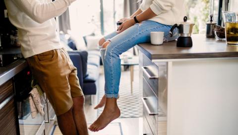 A young couple at home in their kitchen