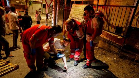 Palestinian paramedics inspect the scene of an Israeli air strike in Tubas, in the occupied West Bank (11 September 2024)